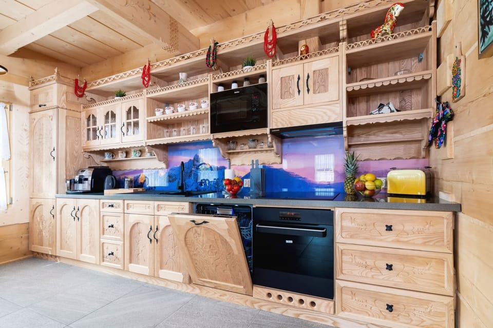 Kitchen with plenty of kitchen utensils and dishes. 