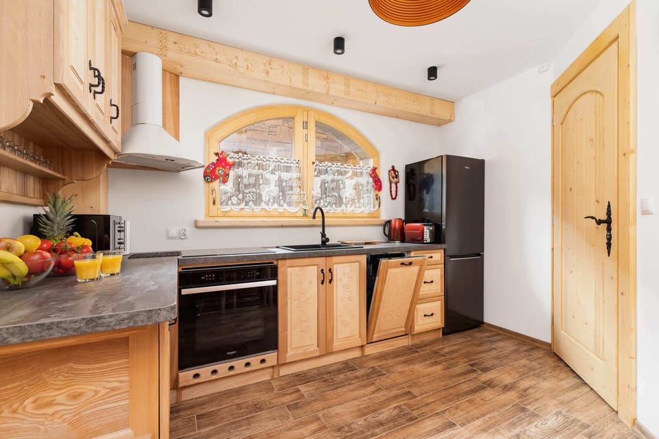 A well-equipped kitchenette with wooden cabinets and a stone countertop, blending functionality with rustic charm.

