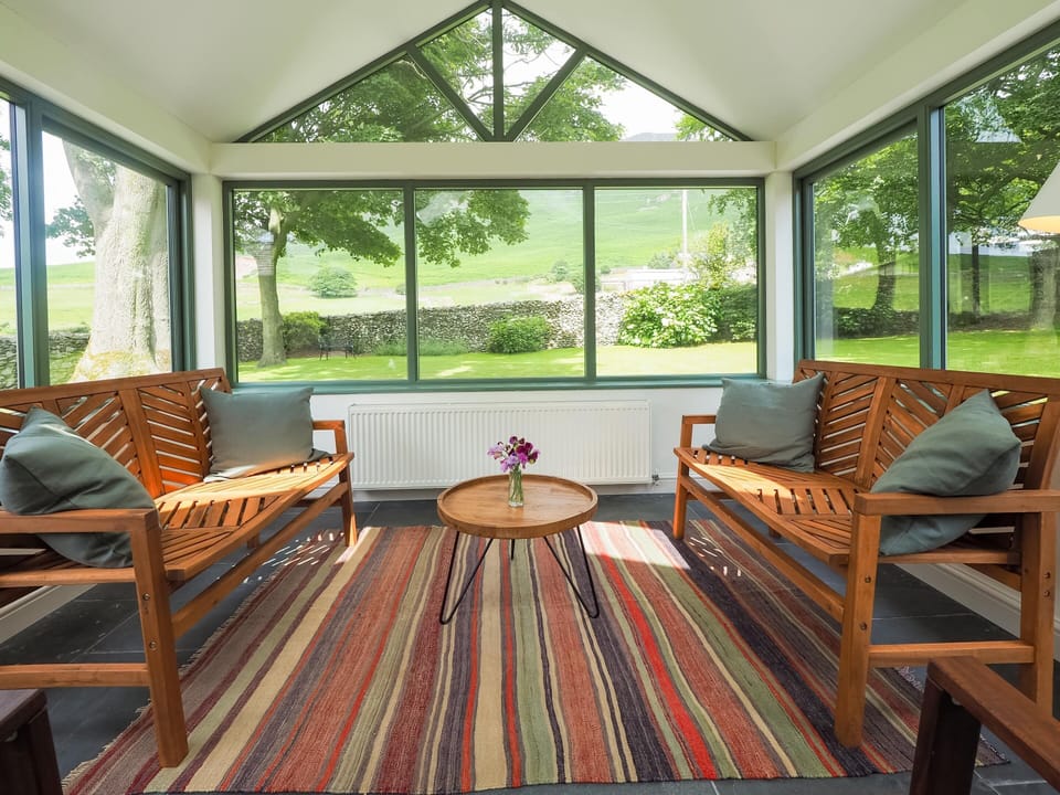 Conservatory with mountain view over the dry stone walls surrounding the garden