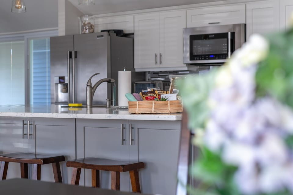 Talk, relax, and eat, at the giant island uniting the kitchen and family room.