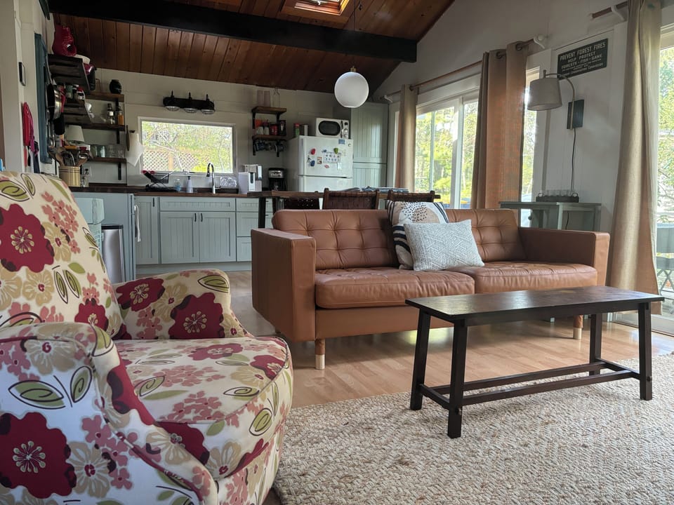 View of open plan living room area with view of the kitchen.