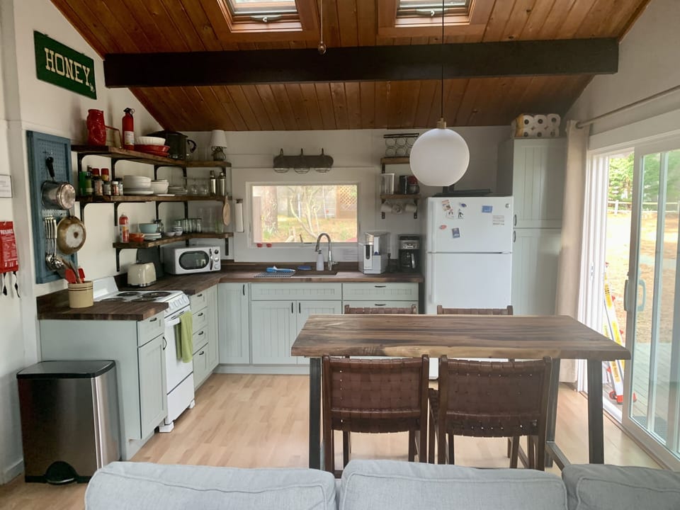 View of the kitchen and counter height table for indoor dining.  