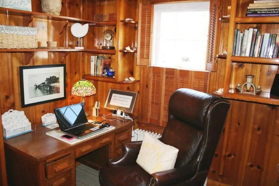 wood paneled office with large comfy leather chair. Also has kids gaming tv.