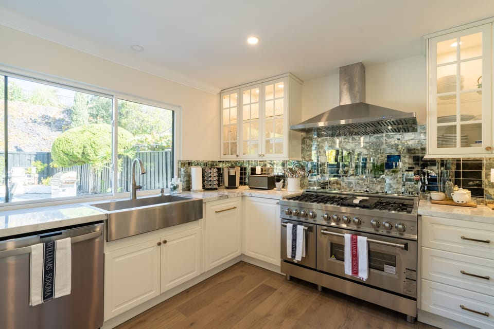 Chefs kitchen with 120" window overlooking pool, GE Dishwasher Kohler 36" sink