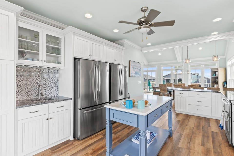 Kitchen fully stocked with wet bar, 2 refrigerators, 2 dishwashers, & island 