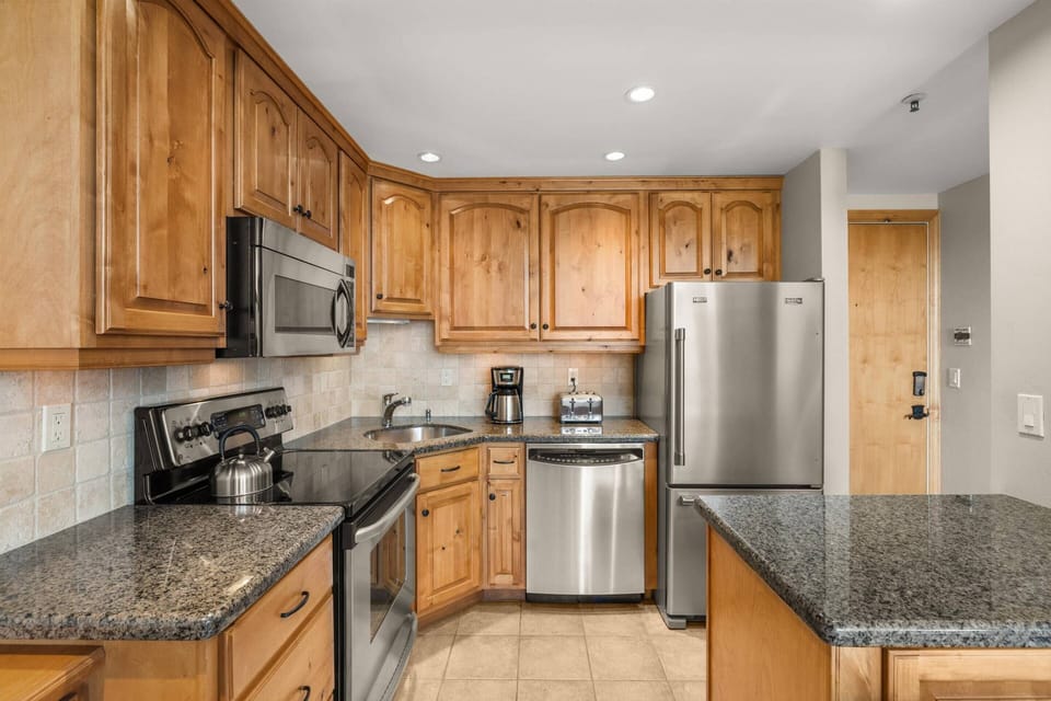 The updated kitchen is fully stocked so you can enjoy meals in your condo during your stay.