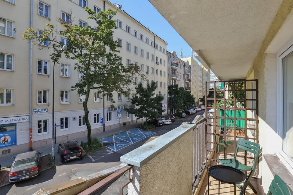 Spacious balcony with outdoor furniture. 