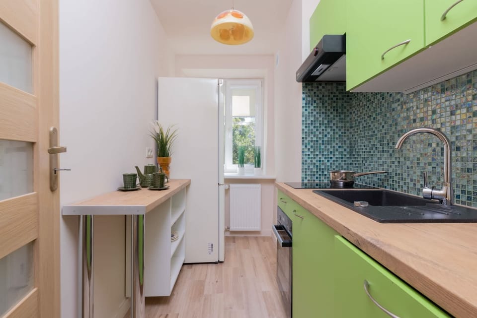Kitchen with plenty of kitchen utensils and dishes. 