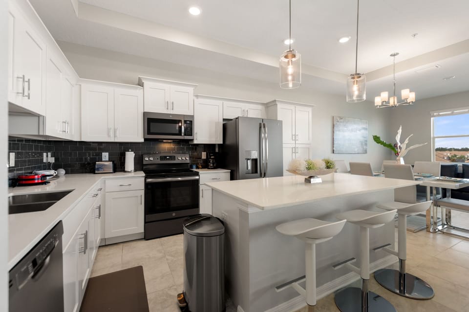 The kitchen is fully-equipped with modern features and with a bar height seating at the counter for 3