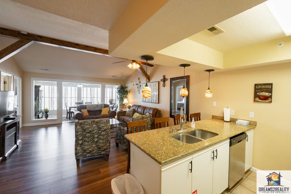 View of Living Room and Sunroom from Kitchen