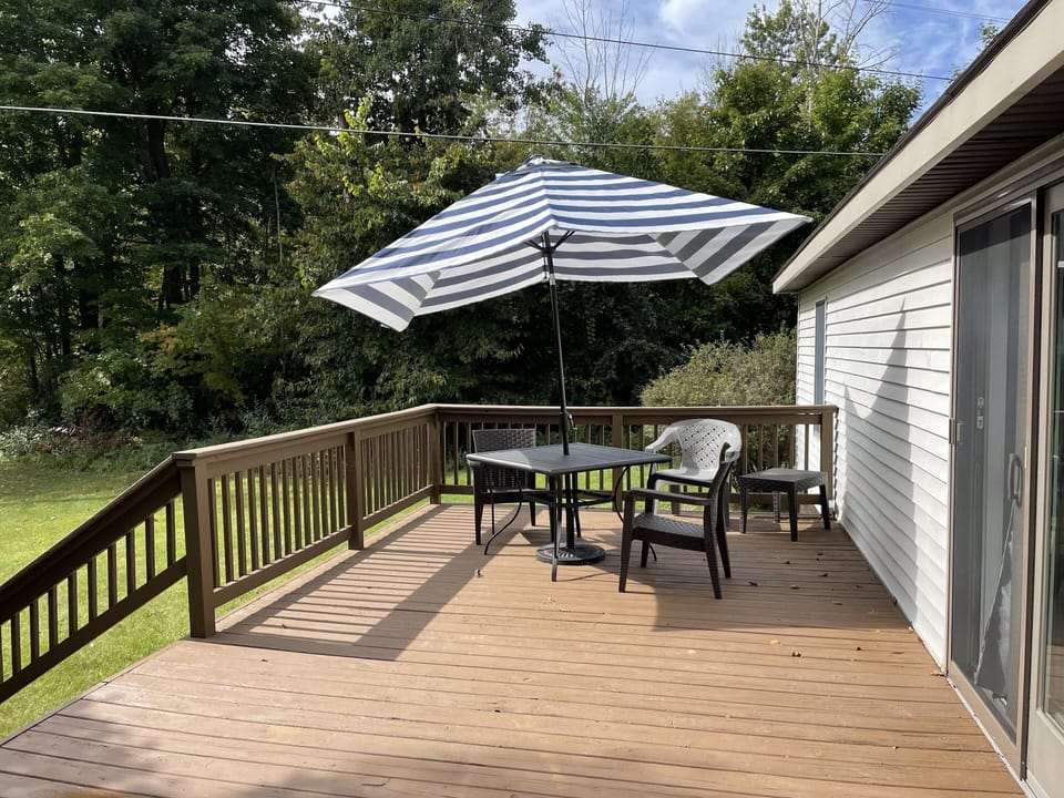 Back deck with table and umbrella. 