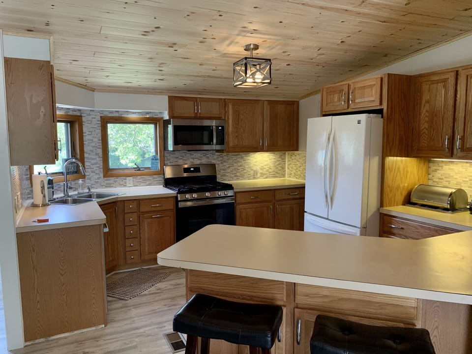 Countertop has 2 bar stools for additional seating space