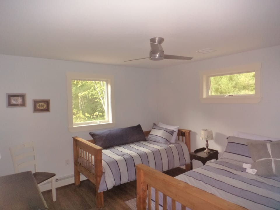 "Kid's room" featuring one queen and one twin bed.