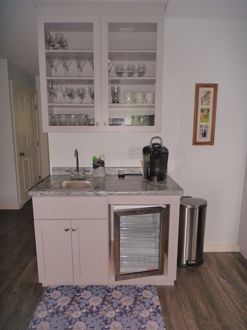 Wet bar with a small refrigerator for beverages.