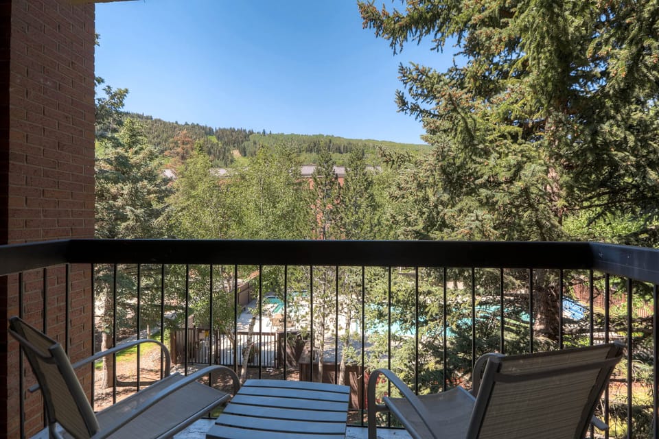 A private balcony has seating for two and views of the mountain.