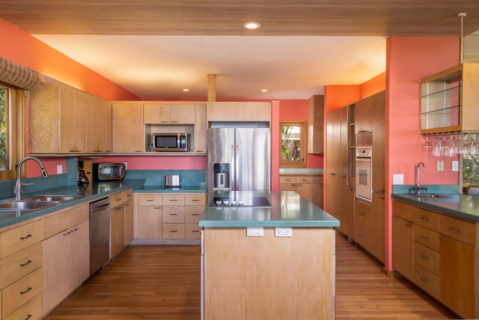 Looking into kitchen from lanai. Laundry room in back area behind refrigerator.
