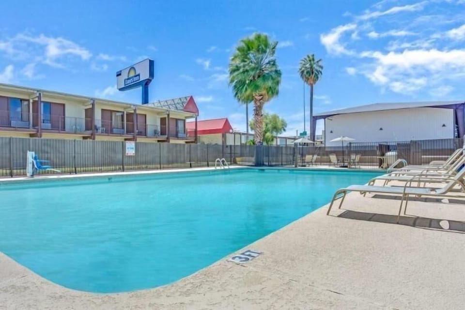 Dive into sunlit refreshment with loungers ready for you.