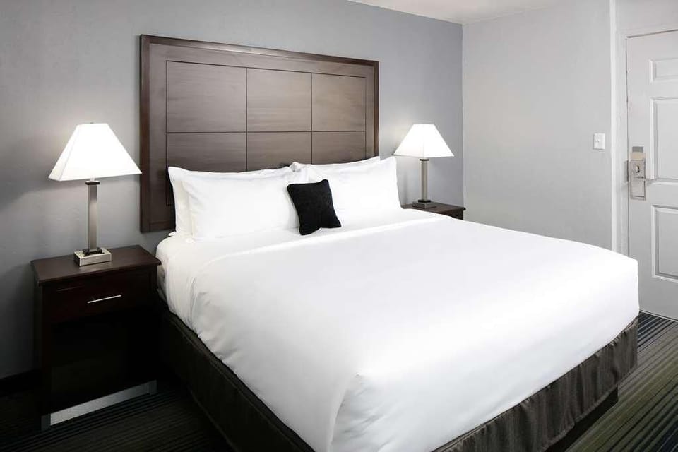 Drift off on crisp white linens and a cushioned headboard.