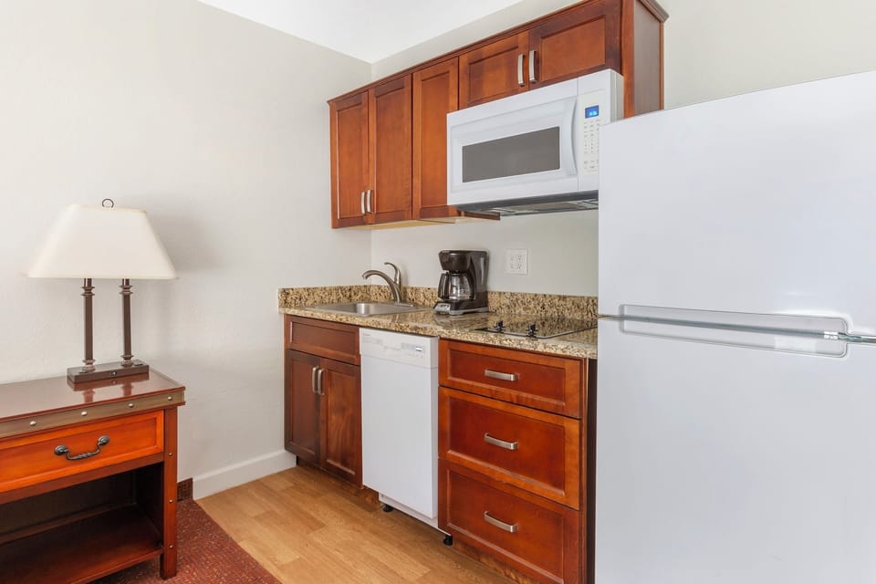 Prepare quick snacks with microwave, fridge, sink, and coffee.