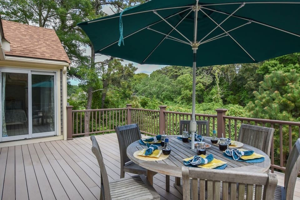 The backyard deck with outdoor dining table set for six.