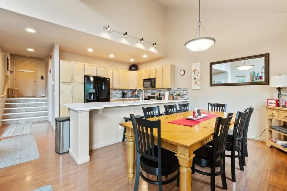 View of the kitchen, dining area, and front door entrance