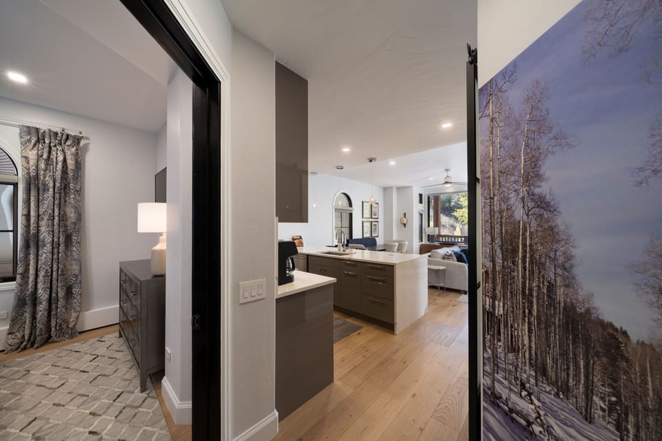 View into first bedroom and kitchen 