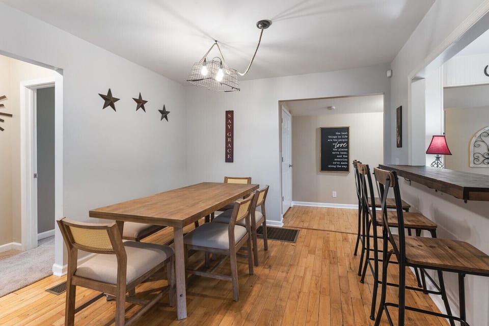 Dining room table with plenty of seating plus additional bar seating at the kitchen counter.