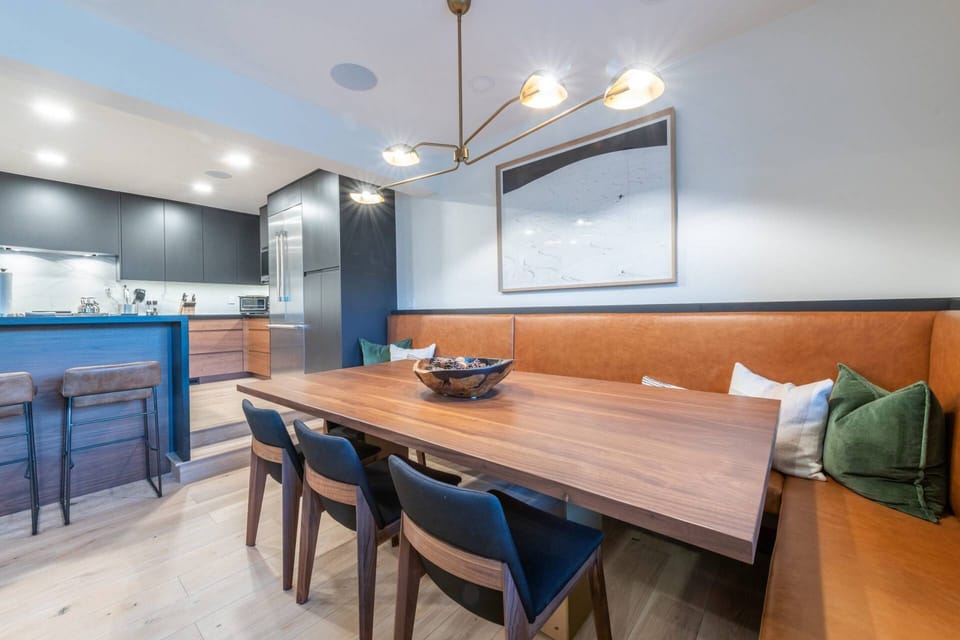 Dining area with custom dining table and banquet that adjoins the living room and kitchen with seating for 8,