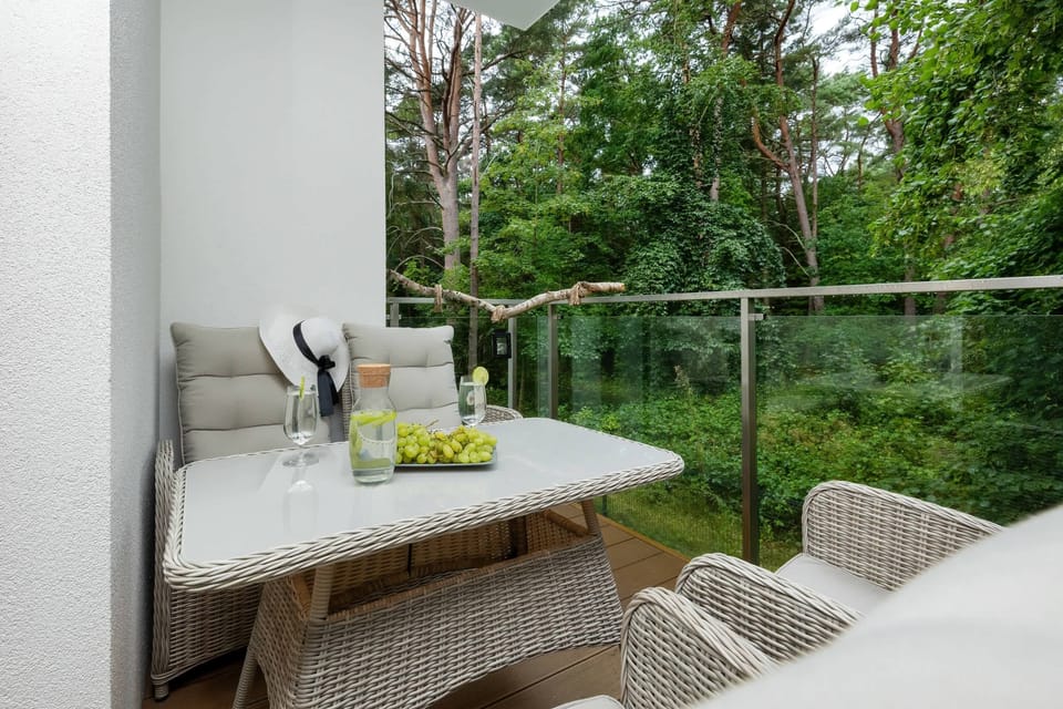 Furnished balcony with green surroundings. 