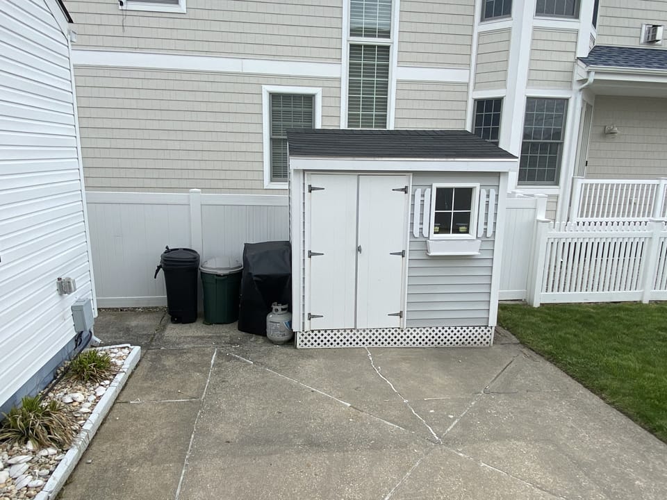 Storage shed with some beach chairs, toys and umbrella 