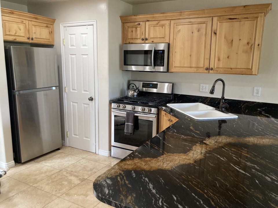 Full size kitchen, fully stocked with new pots and pans and utensils. 