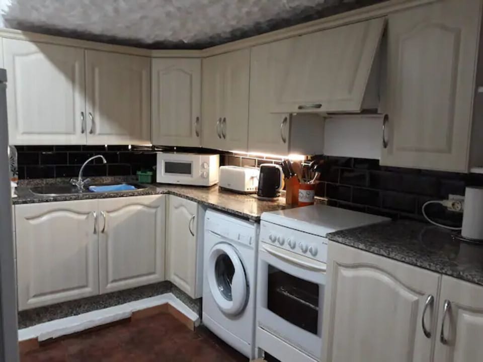 The fully equipped separate kitchen is spacious & has a window to a patio