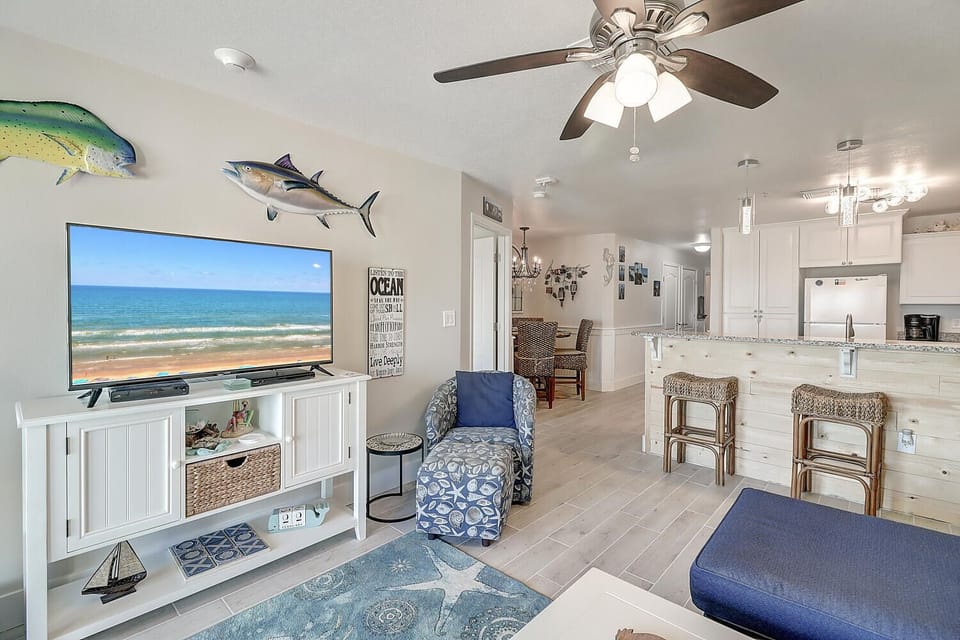 Sink into coastal comfort in your bright, airy living space where ocean-themed décor and natural textures create the perfect beach retreat atmosphere.