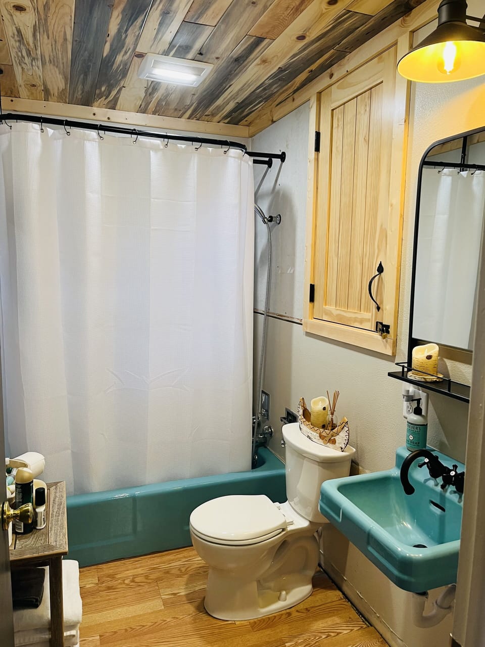 Upstairs bathroom has combined tub with shower, toilet and sink. 
