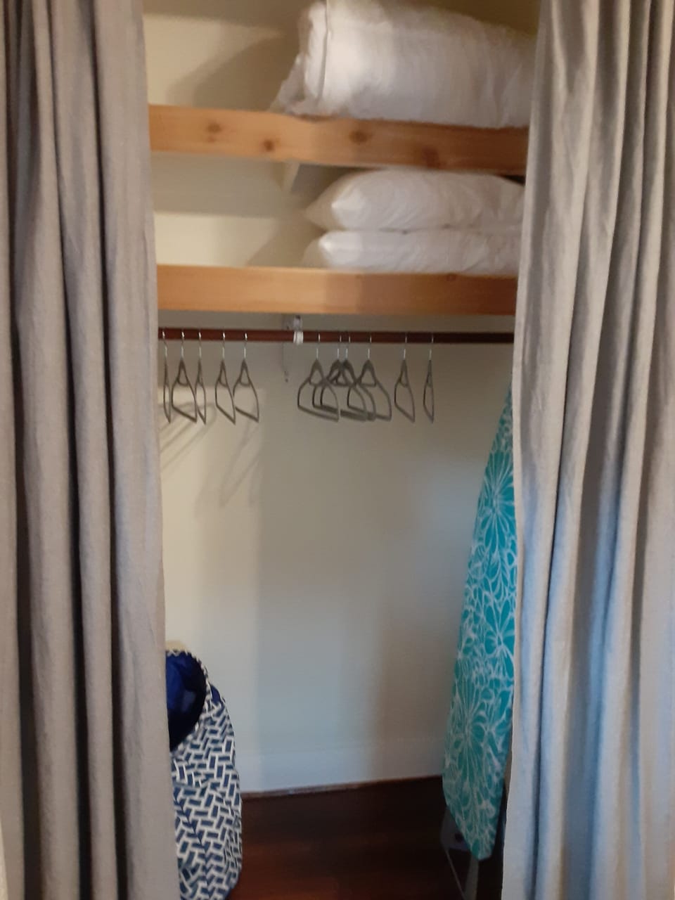 Closet with ironing board and extra linens