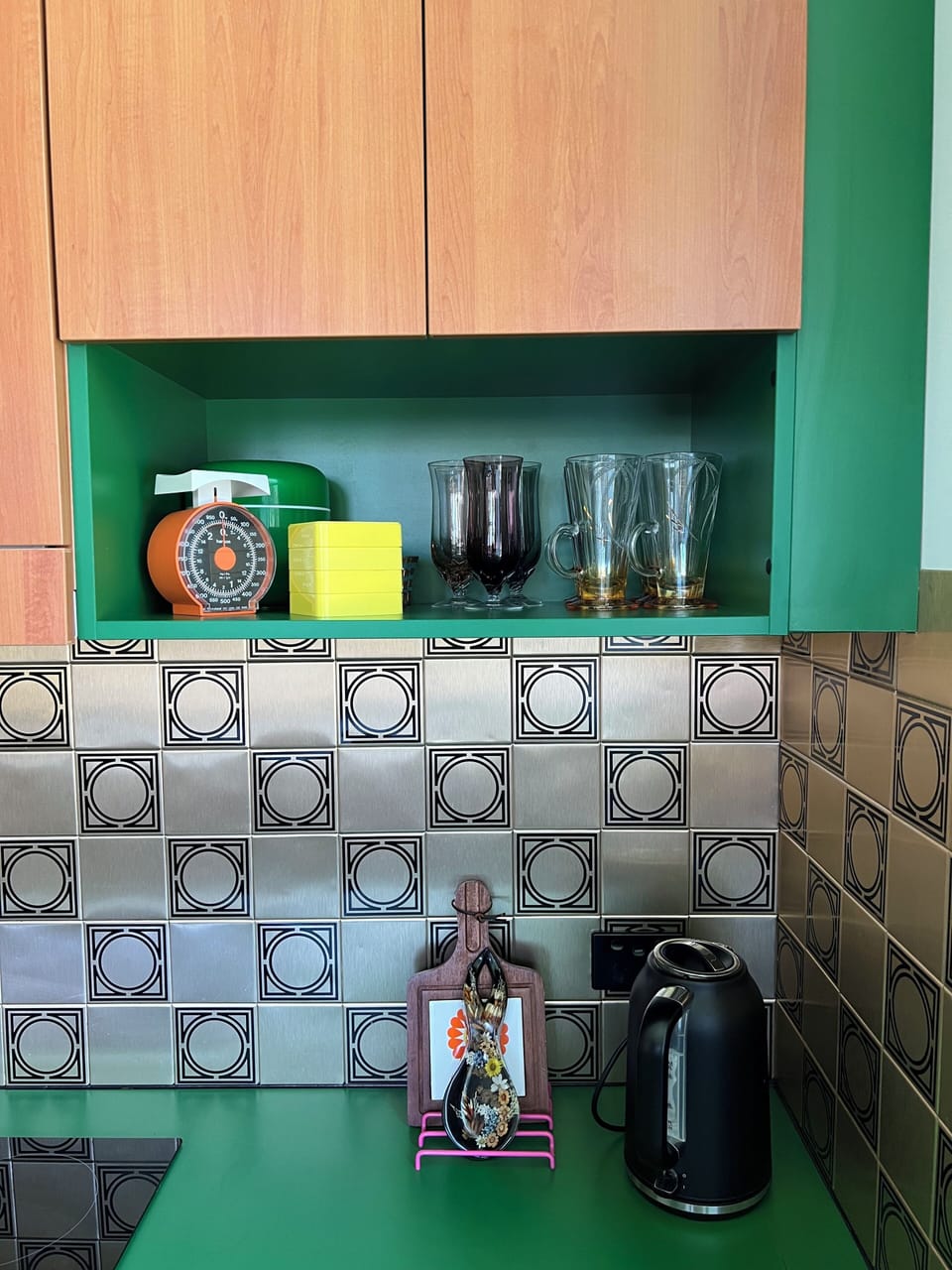The gorgeous green kitchen combines vintage charm with modern convenience.