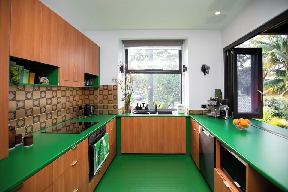 The gorgeous green kitchen combines vintage charm with modern convenience.