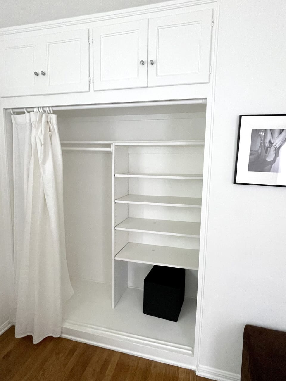 Storage / closet in room with double bed.