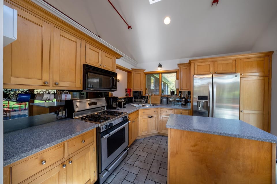 The kitchen area, connected to the large patio and living room area.
