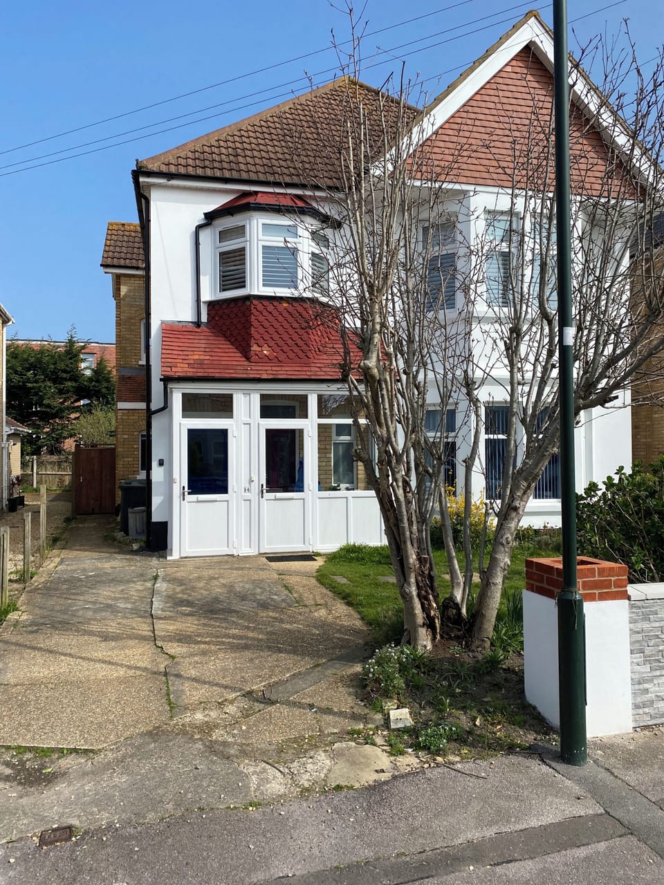 Front of property (private entrance porch on left) & garden access through gate 
