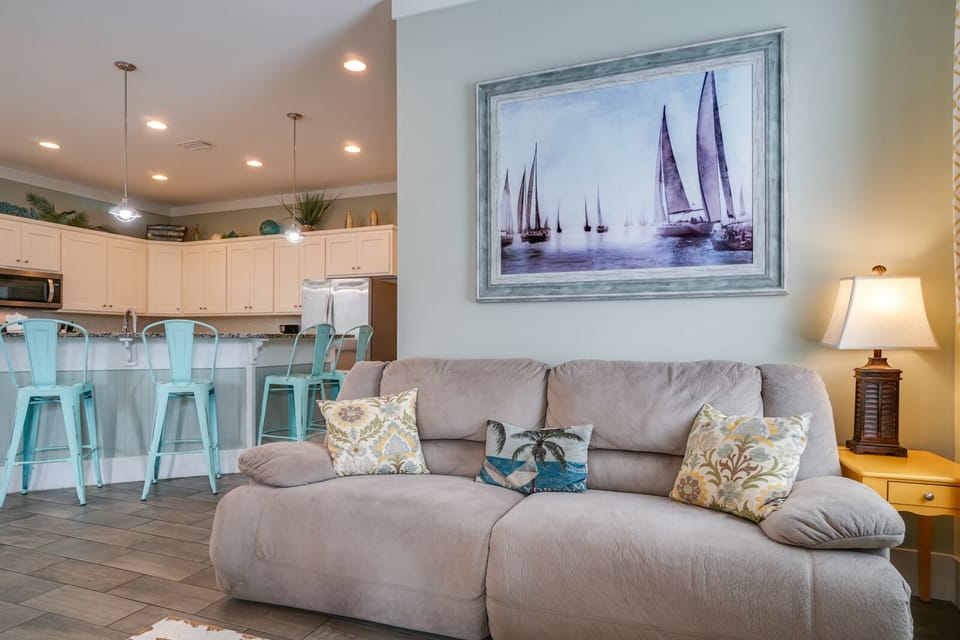 Sink into your comfortable living space where coastal charm meets modern comfort, perfect for unwinding after beach adventures.