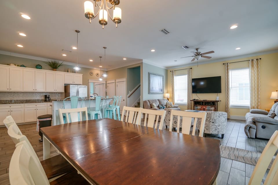 Gather your loved ones around this spacious dining table that flows seamlessly into your fully-equipped kitchen and cozy living room.