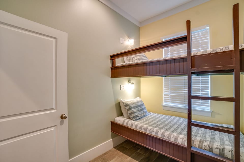 Rest peacefully in your cozy bunk room, where warm wood tones and soft linens create the perfect retreat after busy days.