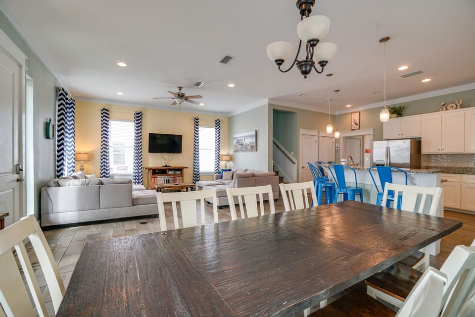 Gather your group around this spacious dining table while enjoying the open-concept flow to your fully equipped kitchen and cozy living area.