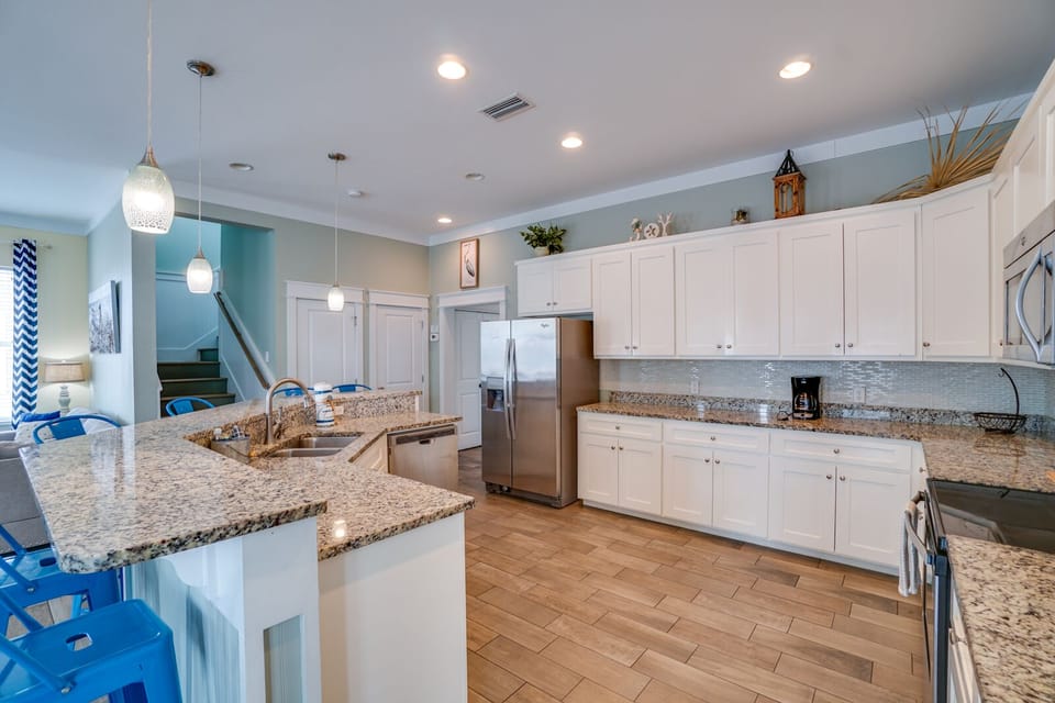 Whip up vacation memories in this spacious chef's kitchen featuring granite counters, stainless appliances, and a perfect island for gathering together.