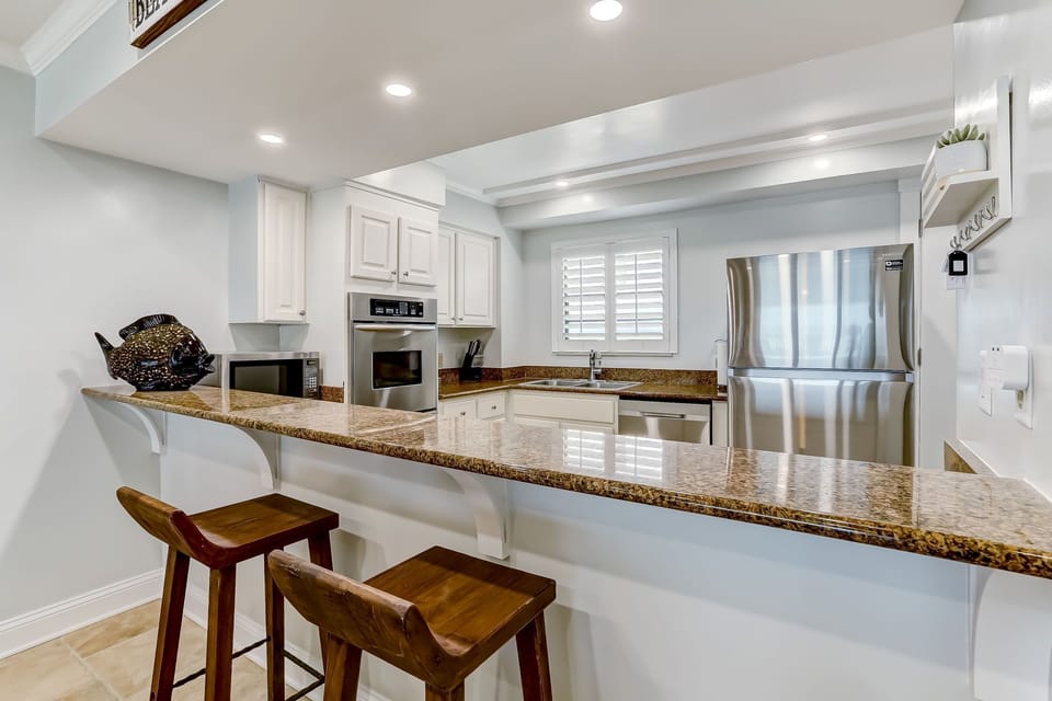 Fully Equipped Kitchen with Granite Countertops, Stainless Steel Appliances, and Gorgeous Ocean Front Views