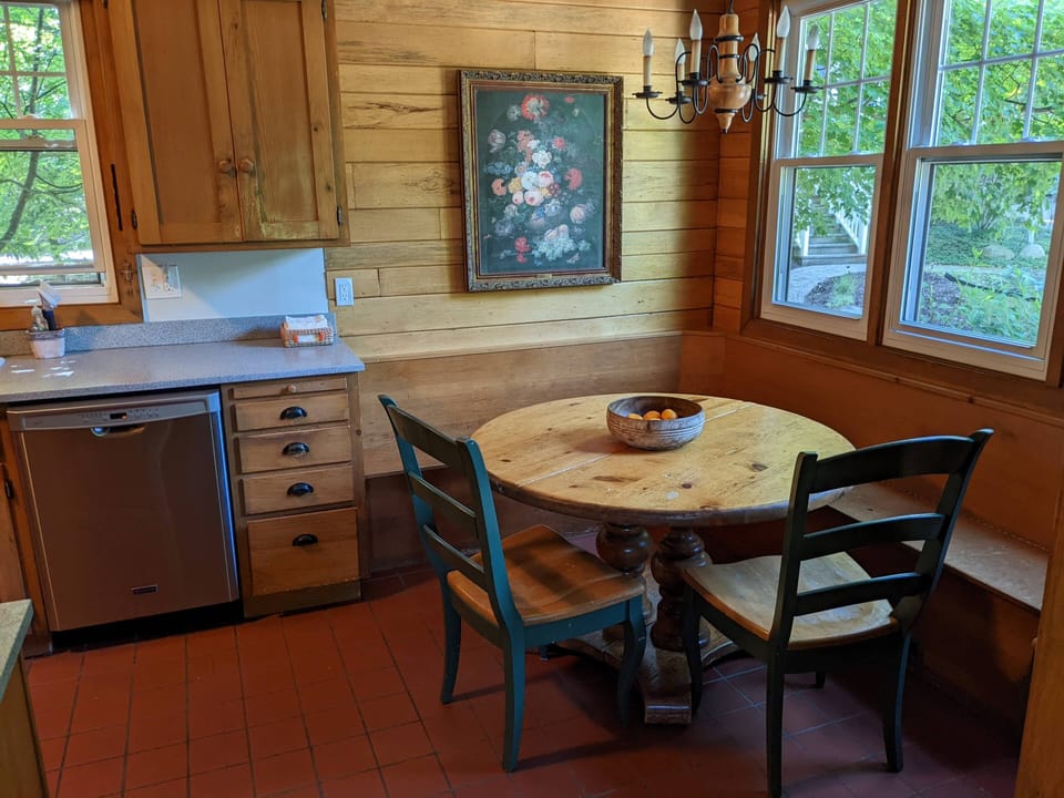 Dining area in kitchen. There are extra leaves and chairs for the table.