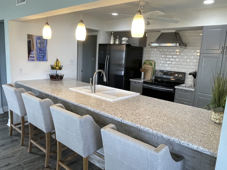 A chef's fully stocked kitchen with All Clad and nonstick cookware.
