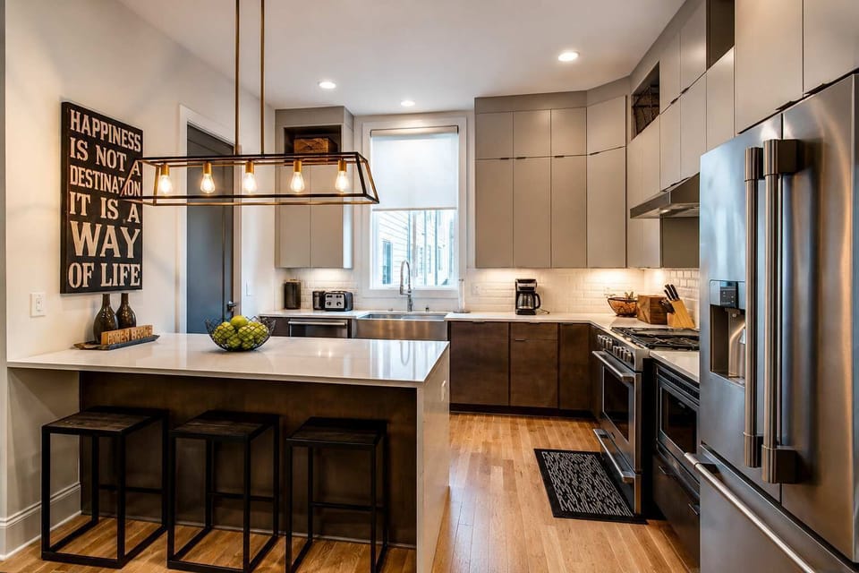 Fully equipped kitchen with an island and seating for three, perfect for casual dining and gathering together.