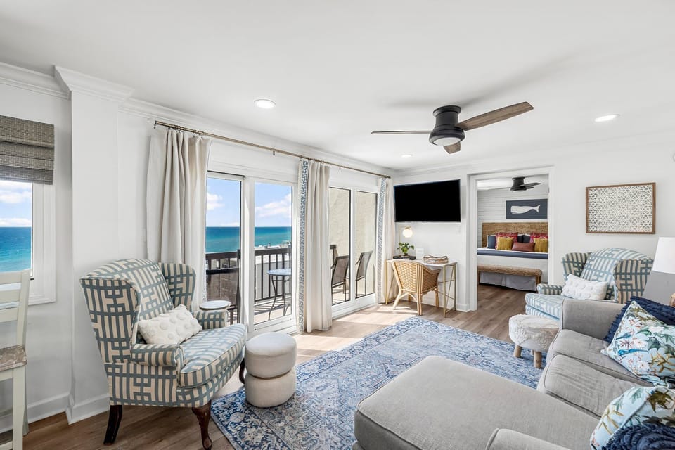 Professionally decorated living room with sectional sofa and ocean views